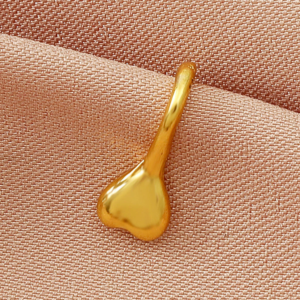 Zircon U-Shaped Leaves Heart Nose Studs in gold, featuring a heart design and U-shaped structure on fabric.